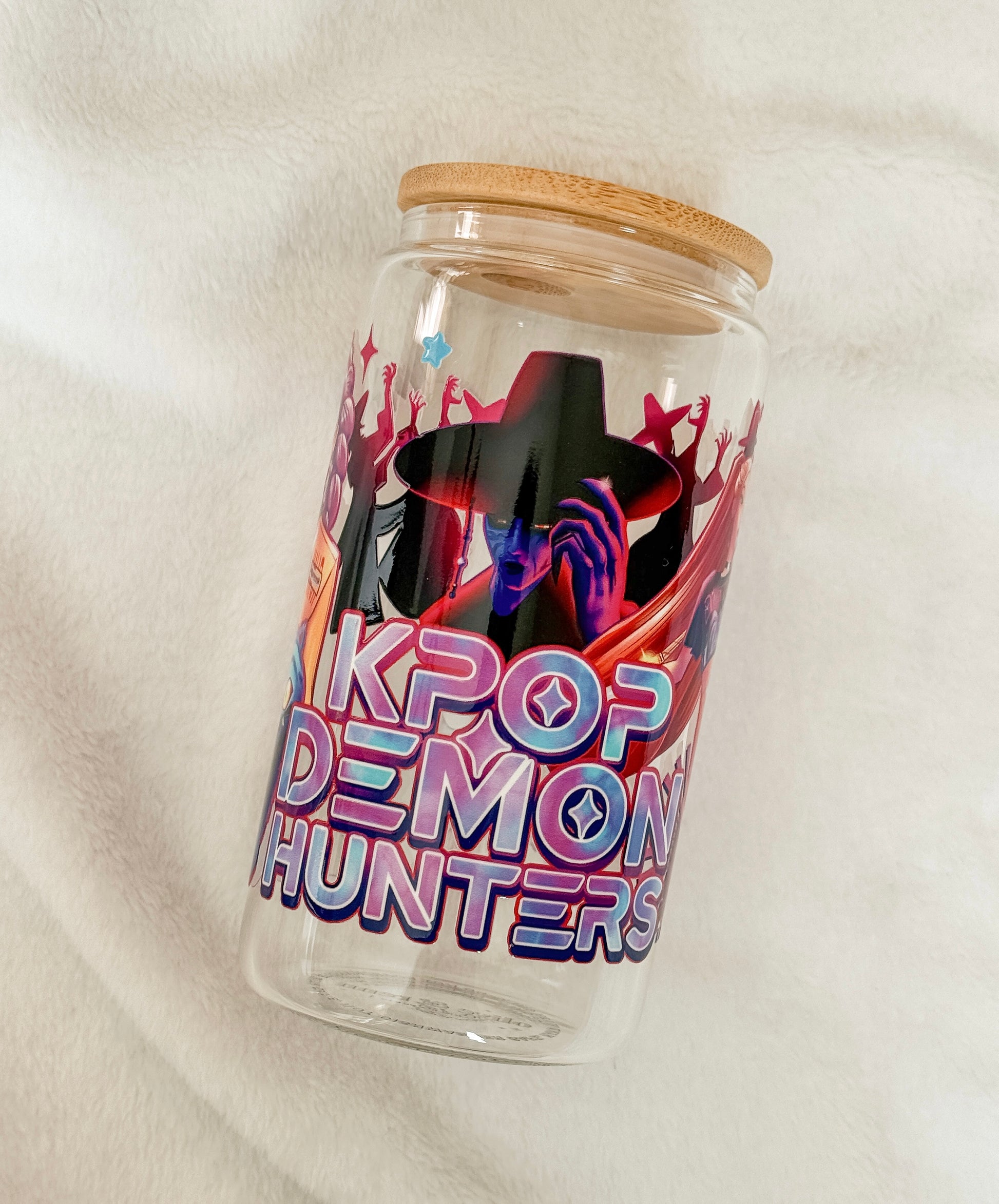 Glass jar with wooden lid featuring 'KPOP DEMON HUNTERS' design on a white background